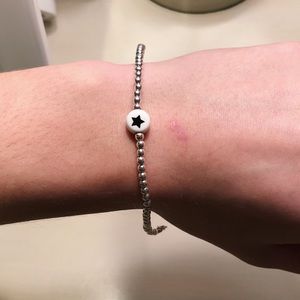 silver beaded bracelet with black and white star